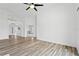Bright living room showcasing sleek wood floors, and an open floor plan at 7744 Country Run Pkwy, Orlando, FL 32818
