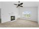 Bright living room with fireplace, ceiling fan, and large window with plantation shutters at 7744 Country Run Pkwy, Orlando, FL 32818