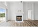 Living room boasts a fireplace, wood floors, and a seamless flow at 7744 Country Run Pkwy, Orlando, FL 32818