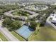 Aerial view of community tennis courts, condo buildings and mature trees at 8211 Sun Spring Cir # 11, Orlando, FL 32825