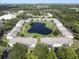 Aerial view of a condo community featuring a central pond, surrounding greenery, and structured building layouts at 8211 Sun Spring Cir # 11, Orlando, FL 32825