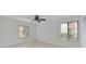 Bright bedroom featuring tile floors, a ceiling fan, and two large windows with blinds at 8211 Sun Spring Cir # 11, Orlando, FL 32825