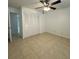 Bedroom with ceiling fan, neutral paint, and a closet at 8211 Sun Spring Cir # 11, Orlando, FL 32825