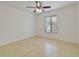 Bedroom featuring tile floors, a ceiling fan, and a large window with blinds at 8211 Sun Spring Cir # 11, Orlando, FL 32825