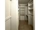 This walk-in closet features built-in shelving and tile flooring at 8211 Sun Spring Cir # 11, Orlando, FL 32825