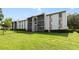 Exterior showcasing meticulously maintained landscaping and architecture of the condo building at 8211 Sun Spring Cir # 11, Orlando, FL 32825