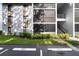 Exterior of a condo building with parking spots in front of it and tree shadows on the left side at 8211 Sun Spring Cir # 11, Orlando, FL 32825