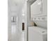 Hallway featuring in-unit washer and dryer, and an entrance to a bathroom and bedroom at 8211 Sun Spring Cir # 11, Orlando, FL 32825