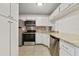 Modern kitchen featuring stainless steel appliances, granite countertops, and white cabinetry at 8211 Sun Spring Cir # 11, Orlando, FL 32825