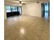Large living room features tile floors, neutral paint, and sliding glass doors at 8211 Sun Spring Cir # 11, Orlando, FL 32825