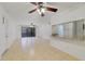 Bright living room with tile floors, ceiling fan, and screened patio access, offering an open and airy space at 8211 Sun Spring Cir # 11, Orlando, FL 32825