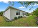 Well-maintained backyard with lush green lawn, manicured landscaping, and a view of the home's exterior at 8336 Sw 77Th Ct, Ocala, FL 34476