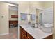 Bathroom with granite counters and a view into the adjacent living area at 8336 Sw 77Th Ct, Ocala, FL 34476