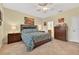 Bedroom with tile floors, ceiling fan, and bathroom and closet doors at 8336 Sw 77Th Ct, Ocala, FL 34476
