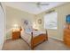 Bright bedroom featuring a ceiling fan, a comfortable bed, and matching nightstands at 8336 Sw 77Th Ct, Ocala, FL 34476