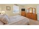 Cozy bedroom with natural light, wooden furniture, and a comfortable-looking bed at 8336 Sw 77Th Ct, Ocala, FL 34476
