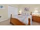 Comfortable bedroom featuring twin nightstands, a double bed, and a spacious closet at 8336 Sw 77Th Ct, Ocala, FL 34476
