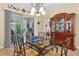 Bright dining room with glass table, decorative chandelier, and sliding glass doors to the backyard at 8336 Sw 77Th Ct, Ocala, FL 34476