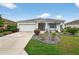 Charming single-story home boasts a manicured lawn and an inviting front porch with a two-car garage at 8336 Sw 77Th Ct, Ocala, FL 34476
