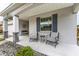 Charming covered front porch with comfortable seating and a view of the meticulously landscaped yard at 8336 Sw 77Th Ct, Ocala, FL 34476
