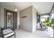Welcoming front porch with stylish seating and decor, complemented by a decorative glass front door at 8336 Sw 77Th Ct, Ocala, FL 34476