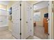 Hallway view showcases doors to the bathroom and bedroom, highlighting the home's layout at 8336 Sw 77Th Ct, Ocala, FL 34476