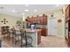 Kitchen island with barstool seating overlooks stainless steel appliances and ample cabinet space at 8336 Sw 77Th Ct, Ocala, FL 34476