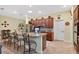 Kitchen island with barstool seating overlooks stainless steel appliances and ample cabinet space at 8336 Sw 77Th Ct, Ocala, FL 34476