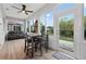 Sunroom features many windows, a dining table, and outdoor access at 8336 Sw 77Th Ct, Ocala, FL 34476