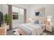Staged bedroom with a neutral color scheme, large windows and decorative art at 879 City Walk Ln, Oviedo, FL 32765