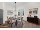 Dining room featuring a glass table, modern chandelier, and neutral decor at 879 City Walk Ln, Oviedo, FL 32765