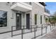 Close-up of townhome entrances with grey doors, stone accents, and handicap-accessible ramps at 879 City Walk Ln, Oviedo, FL 32765
