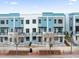 Modern townhome exterior with blue and gray accents, balconies, and landscaped front walkways at 879 City Walk Ln, Oviedo, FL 32765