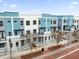 An eye-level view of the modern exteriors of the townhomes, showing the stylish blue and gray color scheme at 879 City Walk Ln, Oviedo, FL 32765