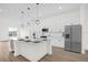 Kitchen with island, pendant lighting, stainless appliances, and wood flooring at 879 City Walk Ln, Oviedo, FL 32765