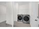 Practical laundry room includes a washer, dryer and a shelf for extra storage at 879 City Walk Ln, Oviedo, FL 32765