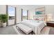 Bright main bedroom features large windows, a bed, bench and elegant decor at 879 City Walk Ln, Oviedo, FL 32765
