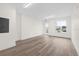 A bright office space showcases a large window and hardwood flooring for a clean aesthetic at 879 City Walk Ln, Oviedo, FL 32765