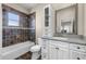 Stylish bathroom with tiled walls and floors, plus vanity storage at 8814 Southern Breeze Dr, Orlando, FL 32836