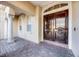 Grand entrance with large wood doors, stone accents, and covered porch area at 8814 Southern Breeze Dr, Orlando, FL 32836
