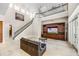 Open concept living room with tall ceilings, iron railing, tile floors and media center at 8814 Southern Breeze Dr, Orlando, FL 32836