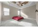 Spacious main bedroom with a tray ceiling, plush carpet and large windows at 8814 Southern Breeze Dr, Orlando, FL 32836