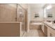 Elegant bathroom featuring a walk-in shower, soaking tub, and double vanity sinks at 8986 Cabot Cliffs Dr, Davenport, FL 33896