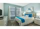 Comfortable bedroom featuring soft, neutral colors, two windows, and stylish furnishings at 8986 Cabot Cliffs Dr, Davenport, FL 33896