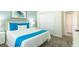 Cozy bedroom featuring a comfortable bed with a colorful accent and a well-lit, inviting ambiance at 8986 Cabot Cliffs Dr, Davenport, FL 33896