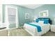 Serene bedroom featuring light blue walls, carpeted floors, and a well-lit ambiance at 8986 Cabot Cliffs Dr, Davenport, FL 33896