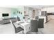 Open concept dining room showcasing a modern table setting, contemporary decor, and seamless transition to the kitchen at 8986 Cabot Cliffs Dr, Davenport, FL 33896