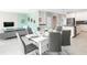 Open-concept dining area featuring a modern table set, seamlessly connected to the living area and kitchen at 8986 Cabot Cliffs Dr, Davenport, FL 33896