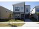 Modern two-story home featuring a minimalist design, neutral color palette, and well-manicured lawn at 8986 Cabot Cliffs Dr, Davenport, FL 33896