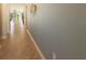 Spacious hallway features neutral wall paint, tile flooring, and decorative wall art, enhancing the home's interior at 8986 Cabot Cliffs Dr, Davenport, FL 33896